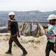 Workers laying a power line carry the team’s lunch boxes at the Dipka Extension mine near Hardi Bazar in Korba. Coal mines have to run electric pumps to drain out any water collected at the bottom of the open pits.